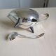 Angora tripod and silver metal spoon