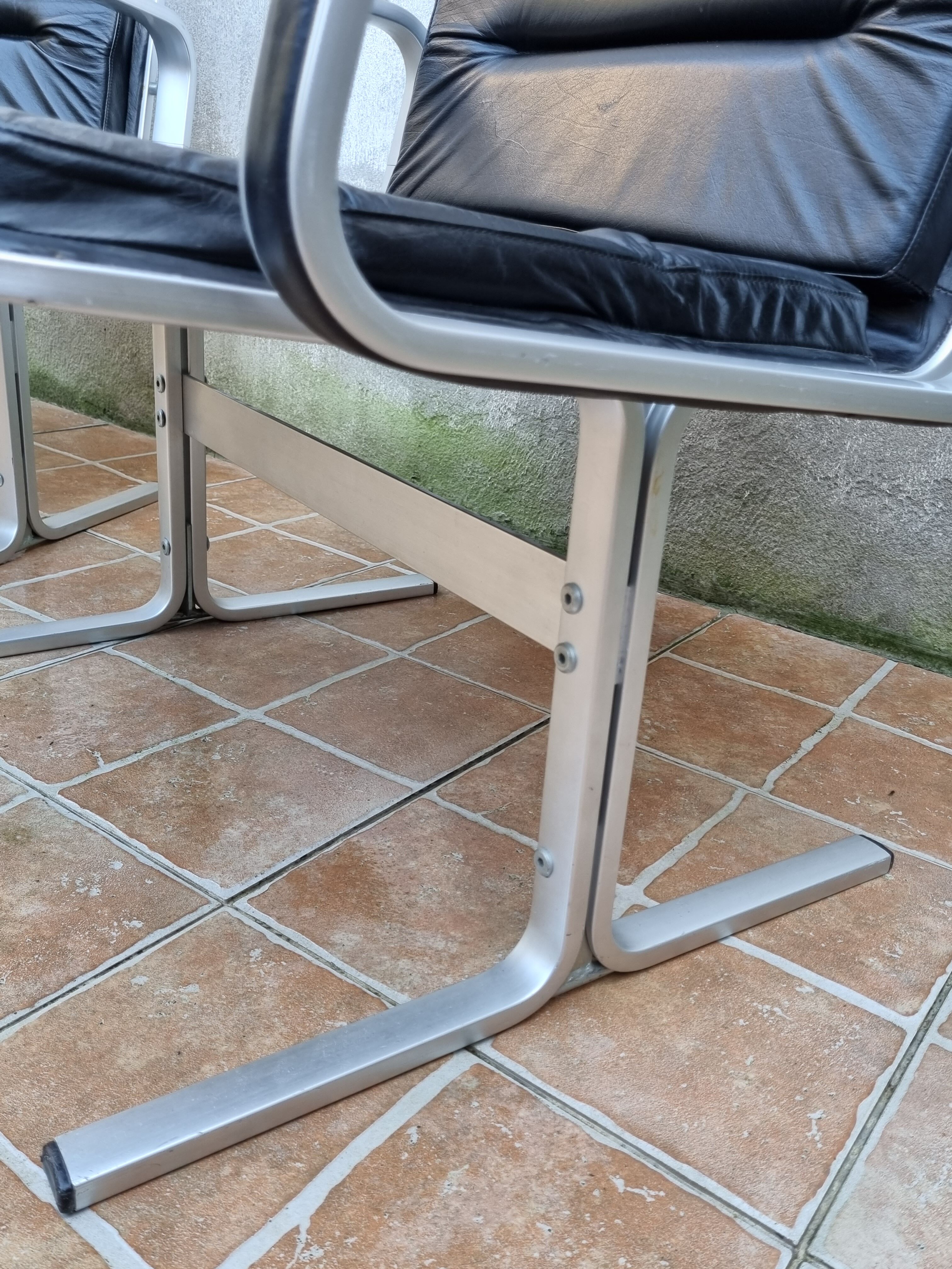 Pair of vintage leather and aluminum armchairs, restored
