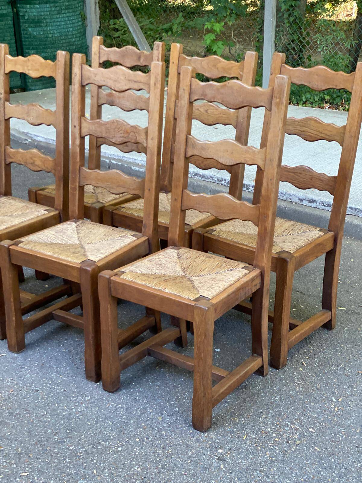 6 solid oak chairs with rush seats in a country style.
