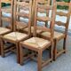 6 solid oak chairs with rush seats in a country style.