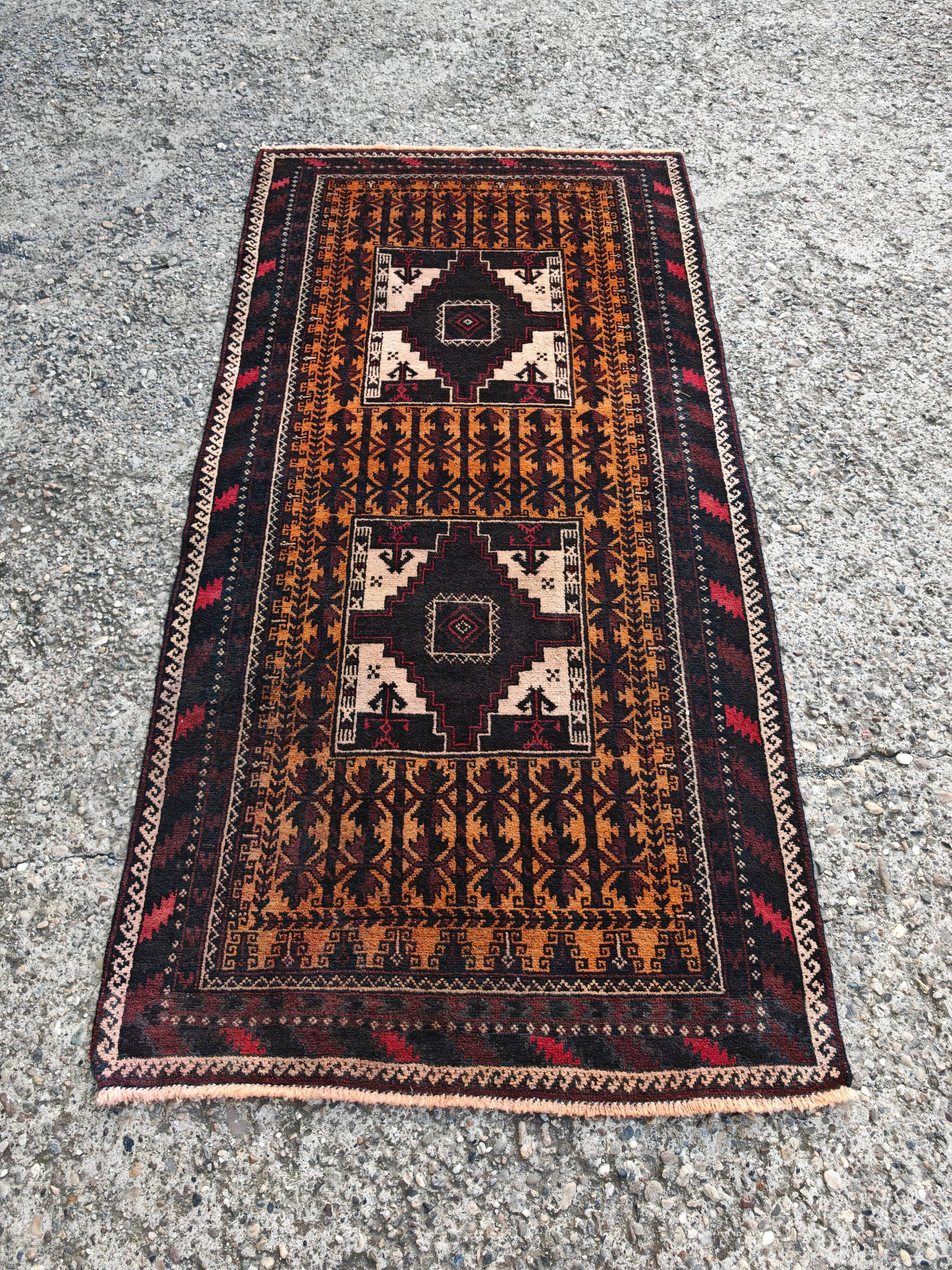 Vintage Persian Baluch rug, hand-knotted wool, 1970.