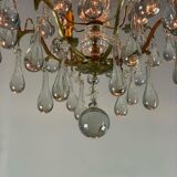 Gilded bronze chandelier trimmed with drop-shaped stamps
