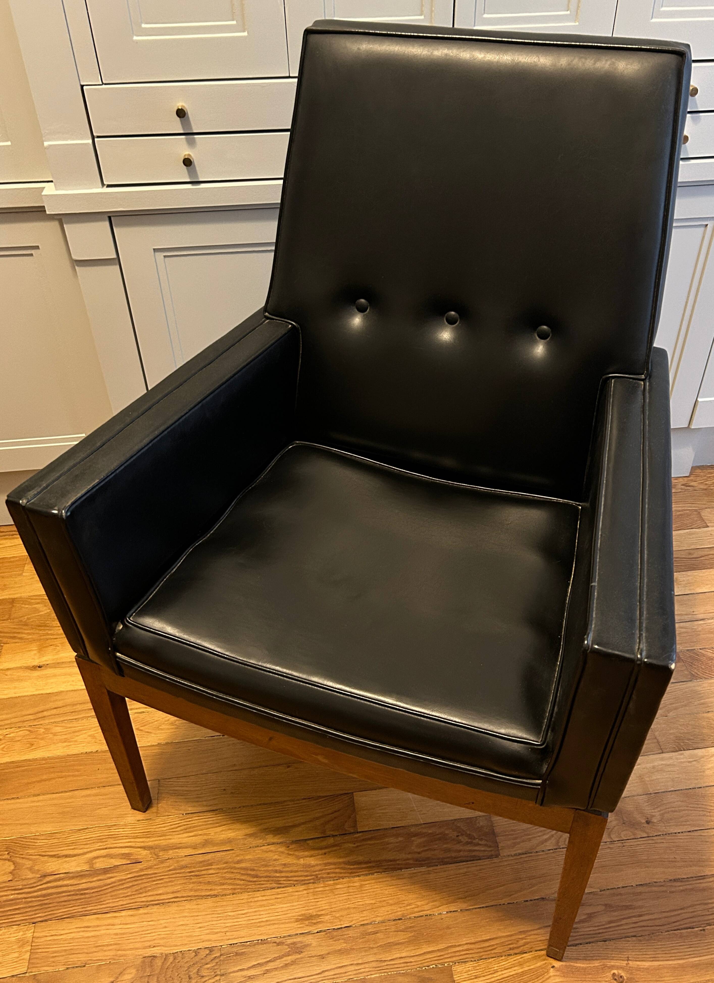 Modernist armchair in wood and black synthetic leather, circa 1960