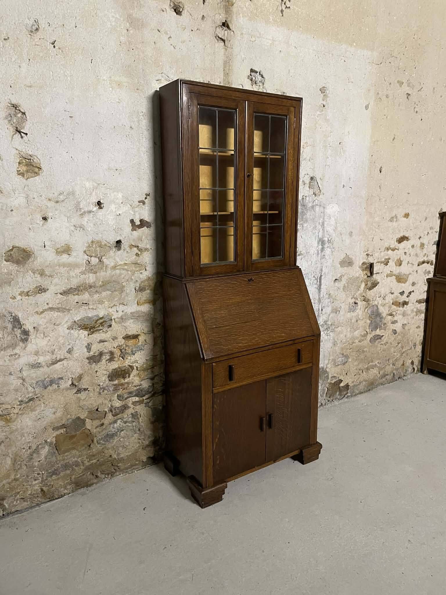 Oak display secretary cabinet with drop-down front, two sections.