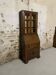 Oak display secretary cabinet with drop-down front, two sections.
