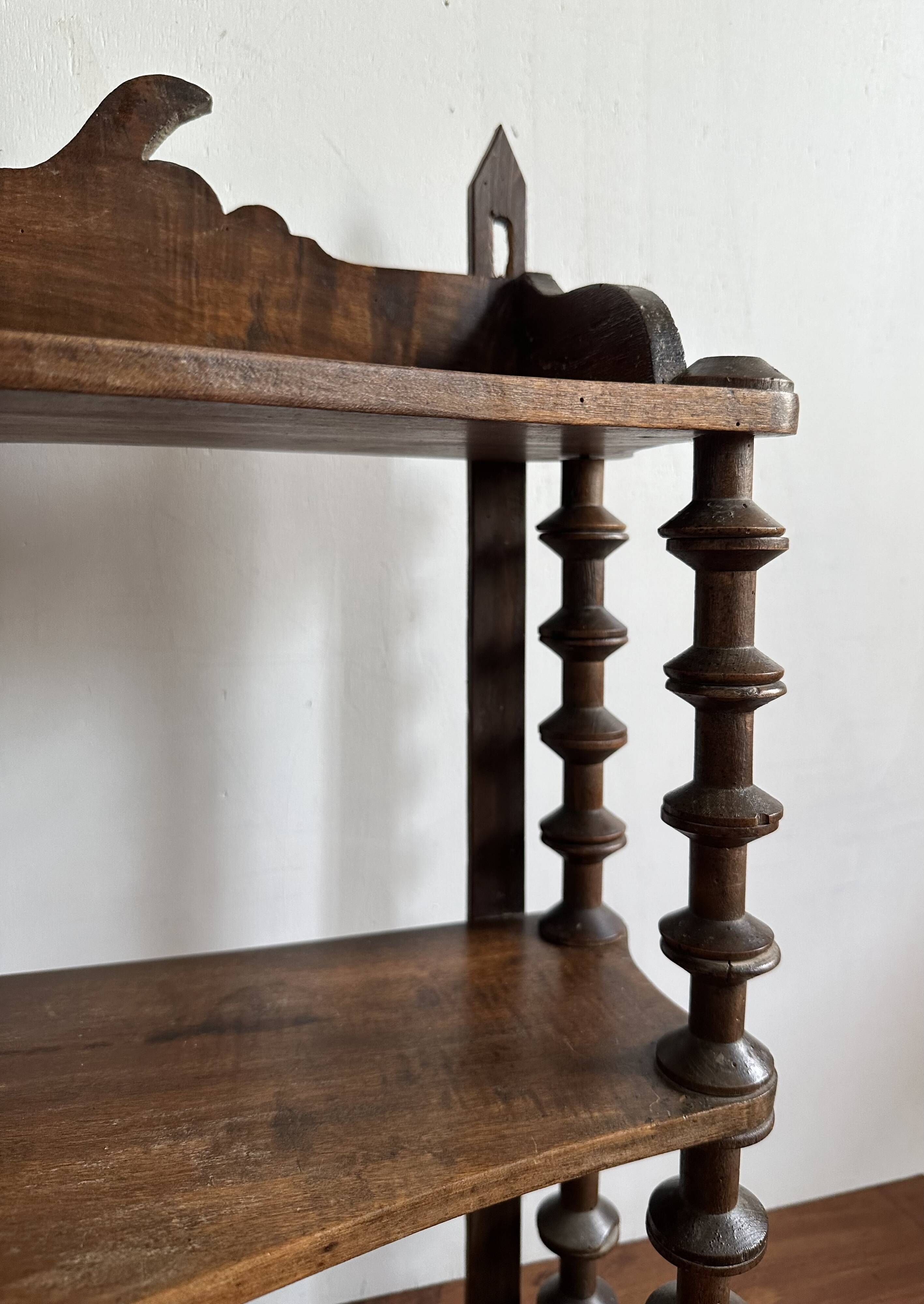 Antique wall shelf made of turned wood and spools of thread, late 19th century.