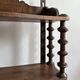 Antique wall shelf made of turned wood and spools of thread, late 19th century.