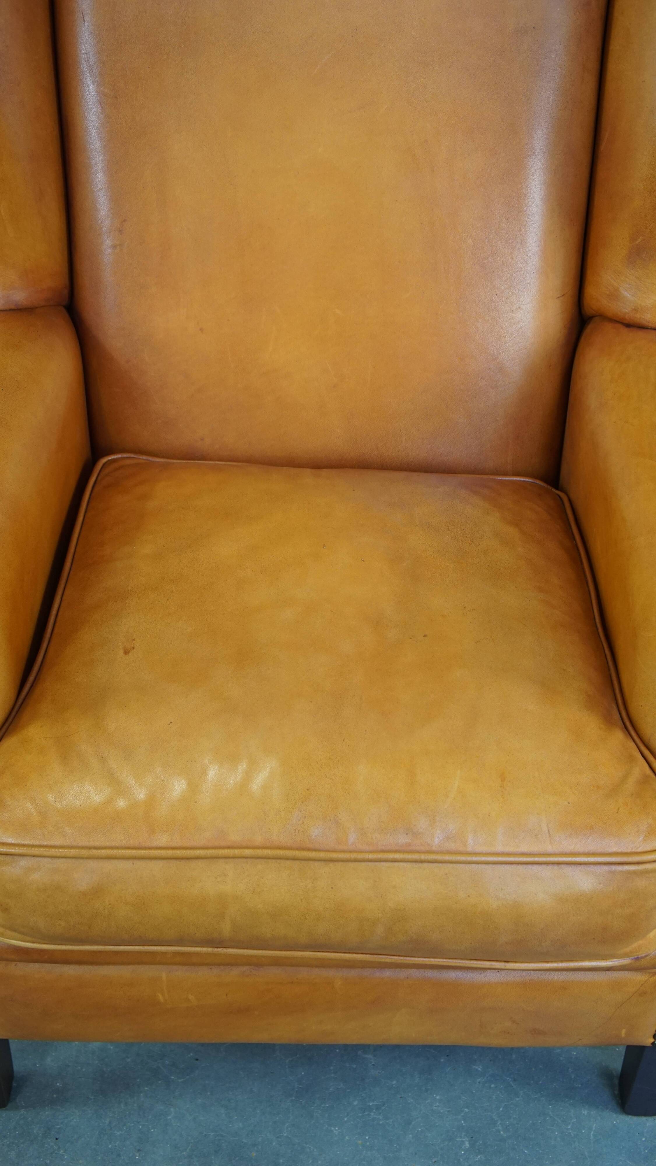 Cow leather wingback chair finished with decorative nails