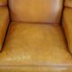 Cow leather wingback chair finished with decorative nails