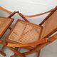 Pair of folding chairs in bamboo and caning, leather and brass