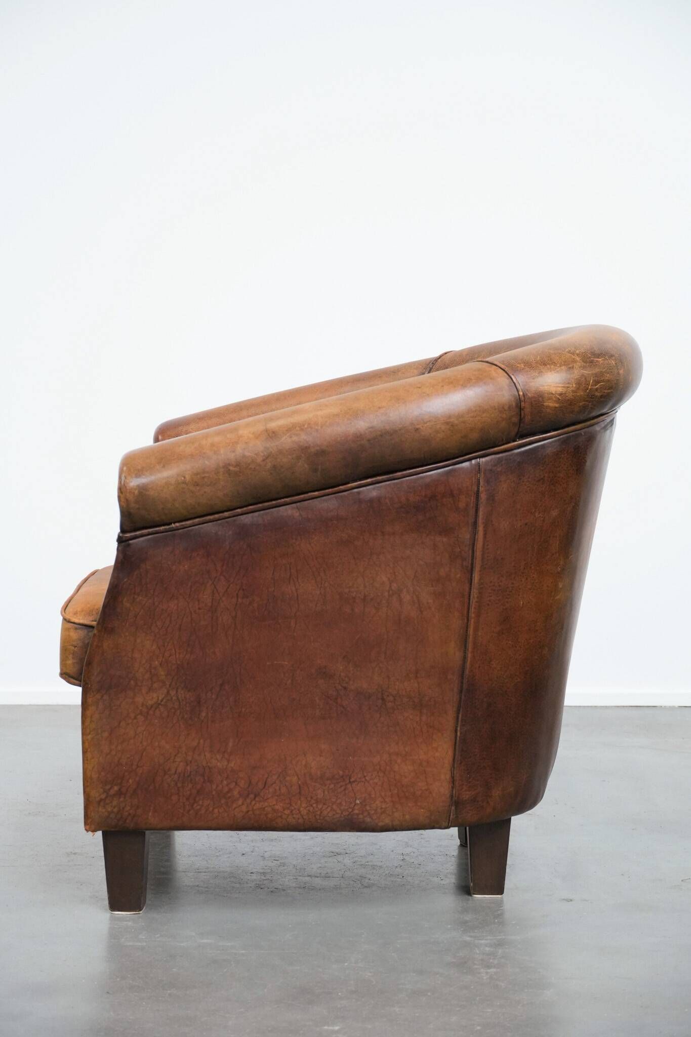 Vintage club chair in sheepskin leather with a characterful look