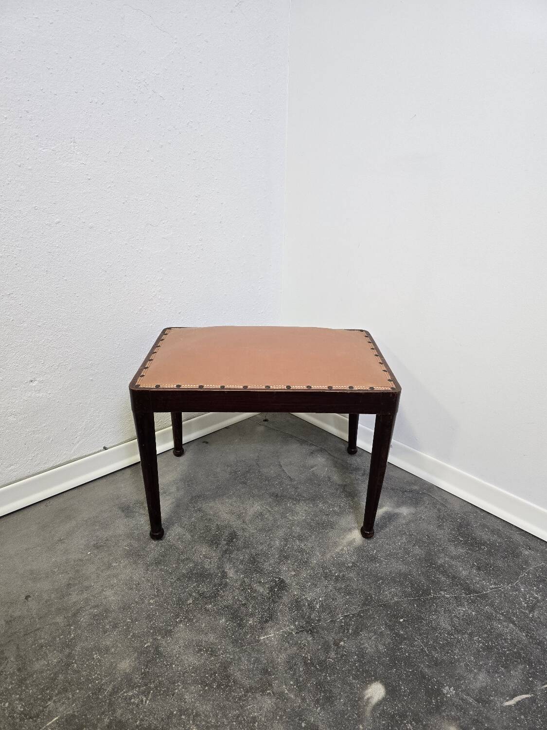 Vintage wooden ottoman from the 1940s with a silk top and studded trim.