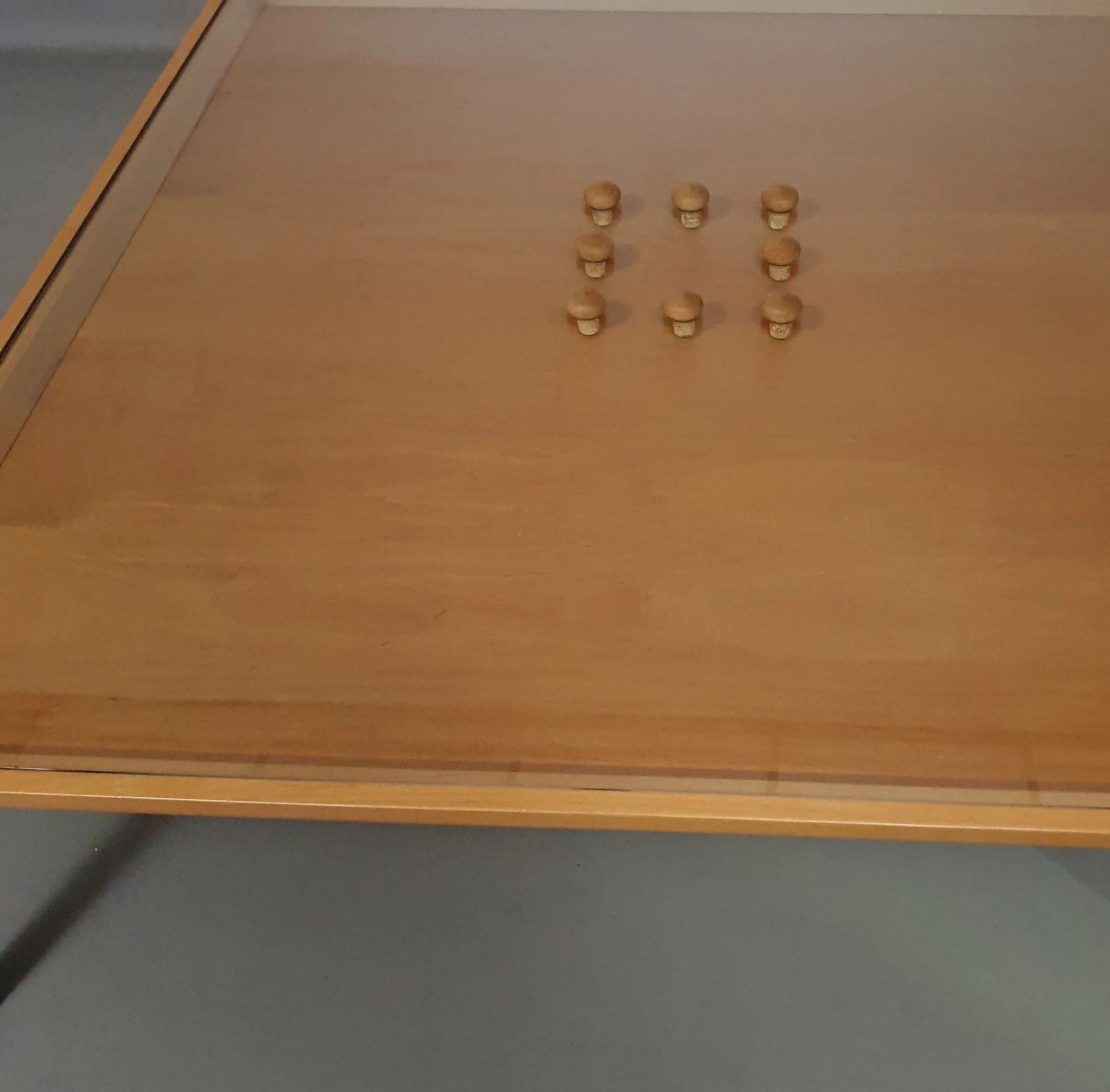 Rare coffee table 110 x 110 x height 35 cm with 8 flange wooden / cork caps in the glass top.