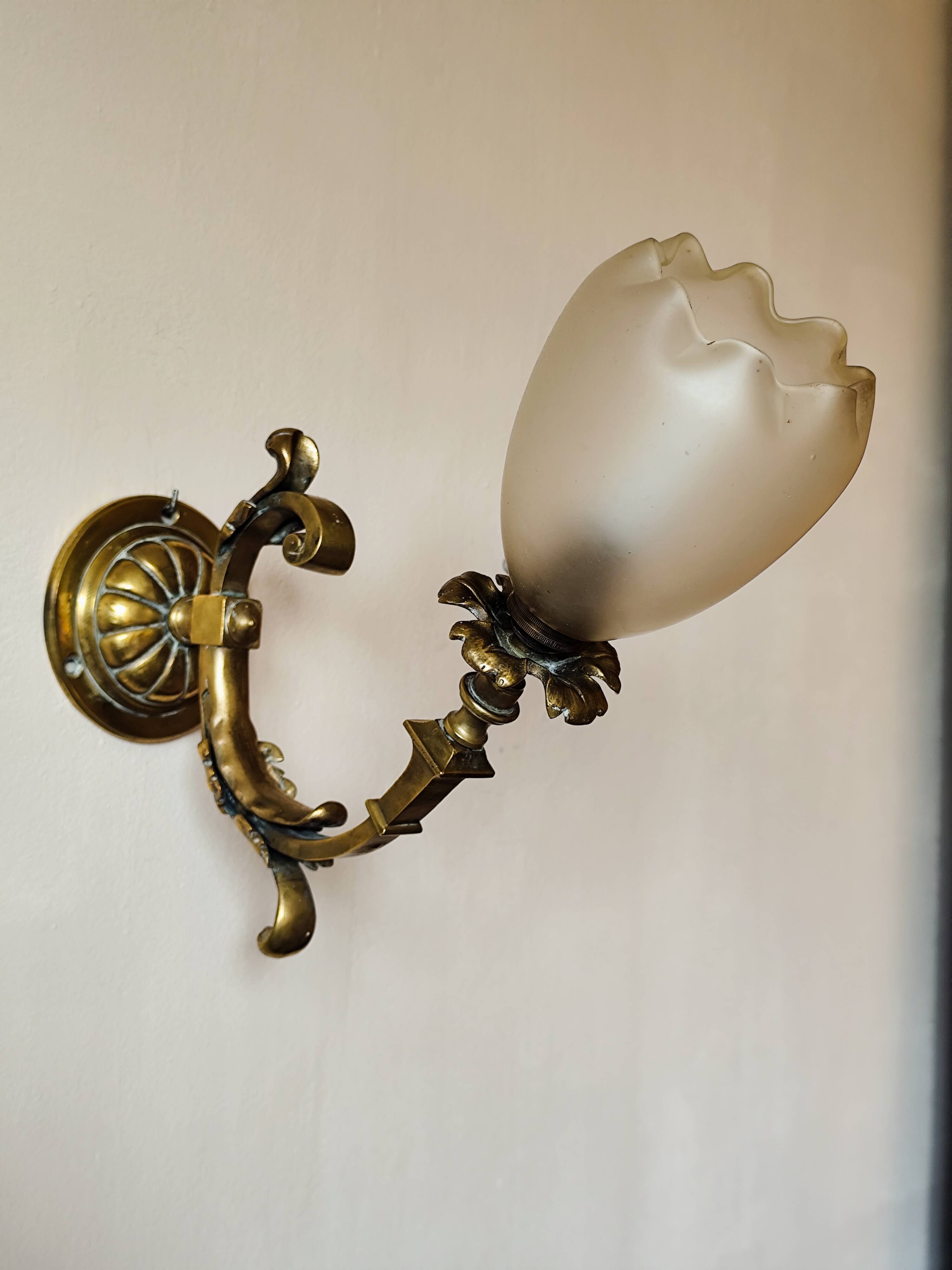 Bronze wall light with opaque glass tulip