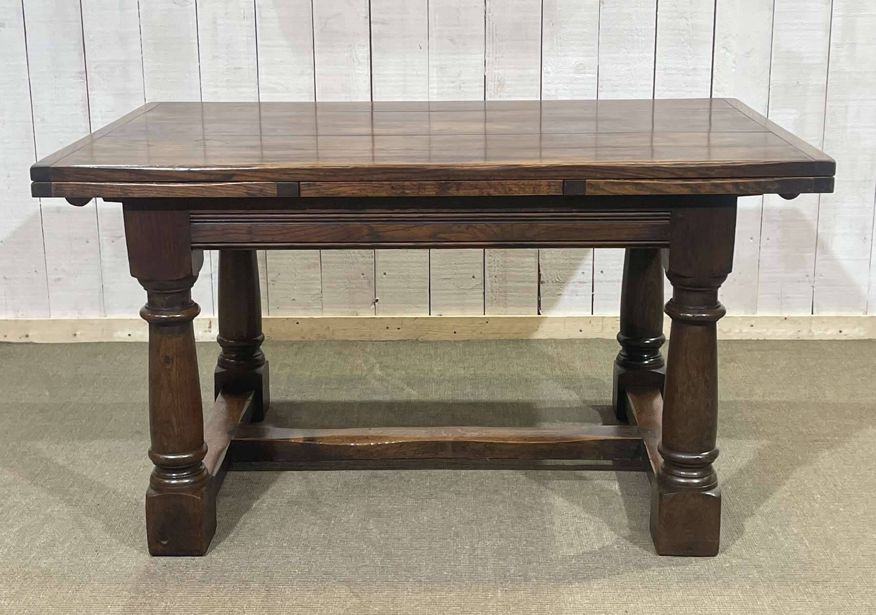 English monastery table with extensions from the late 19th century in elm and oak.