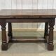 English monastery table with extensions from the late 19th century in elm and oak.