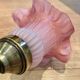 Pair of brass sconces and pink glass