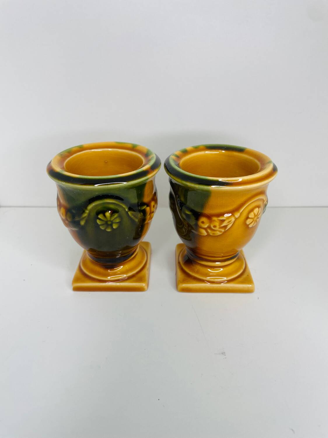 Pair of ocher and green ceramic point-a-line candlesticks