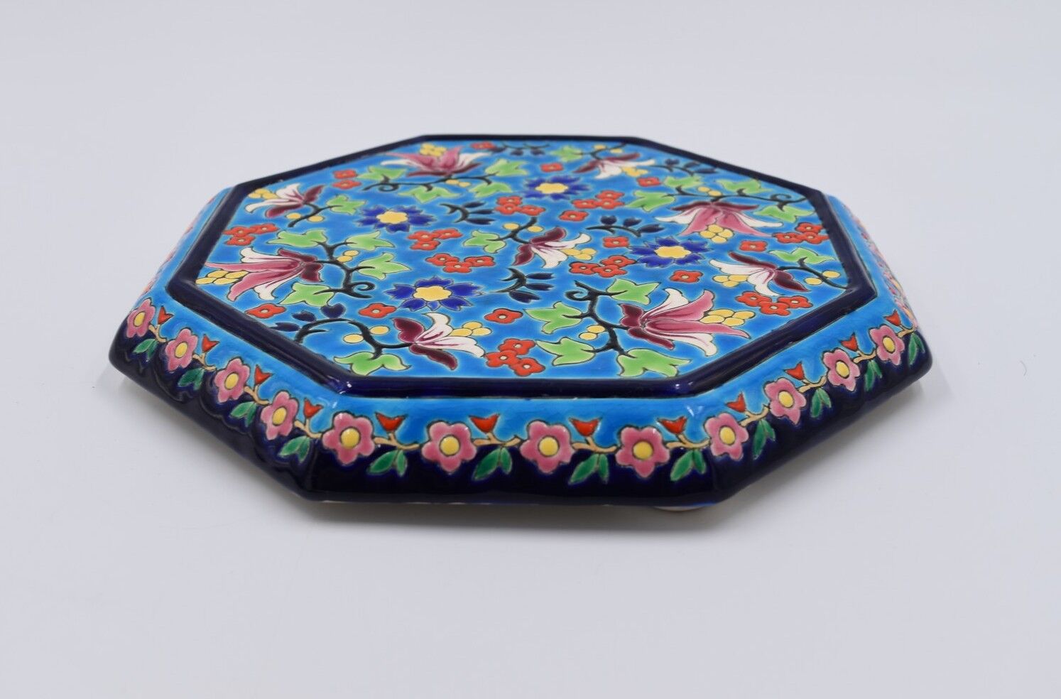 A flat bottom and two enamel bottle bottoms of Longwy