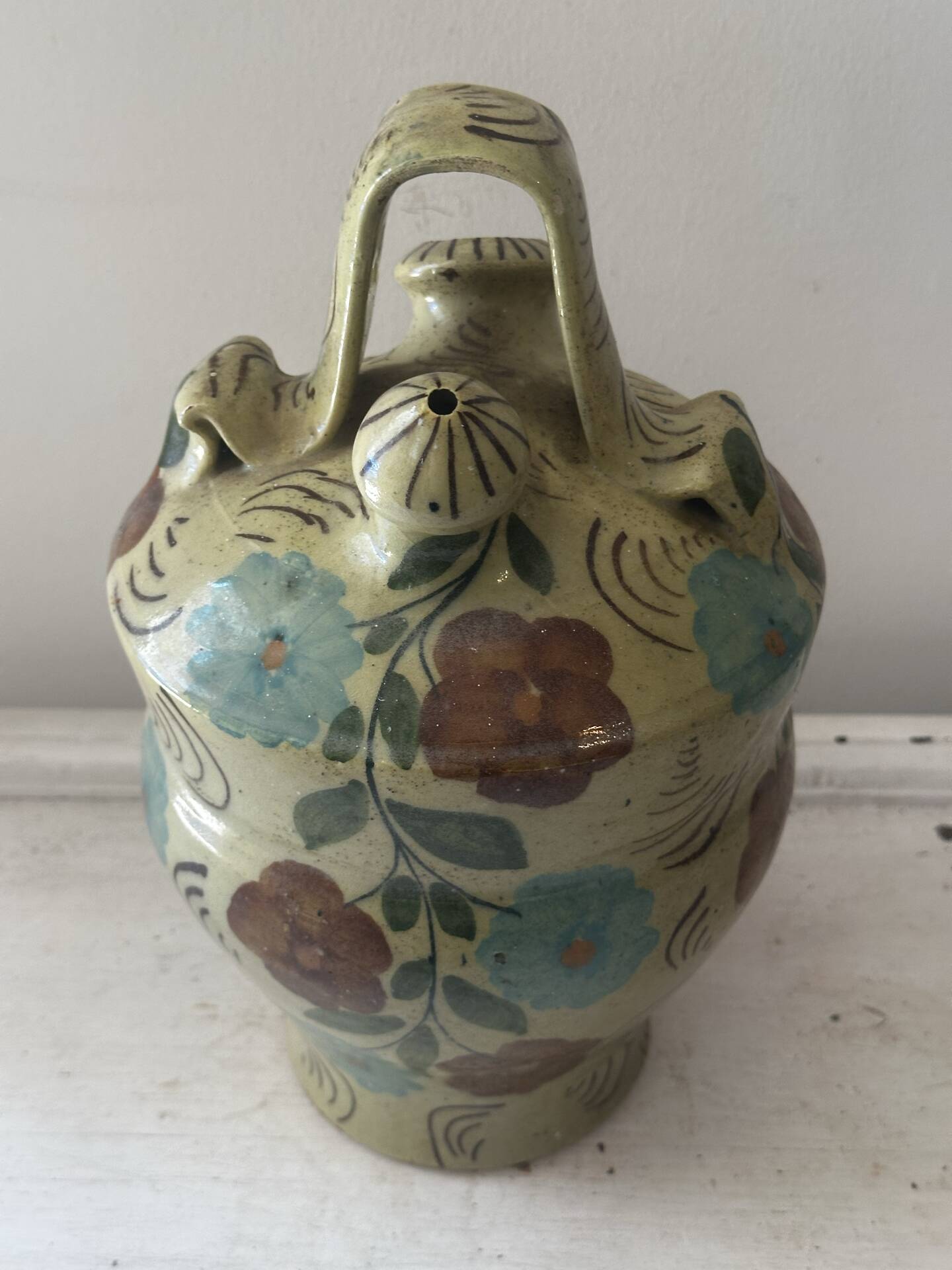 Mediterranean ceramic jug with floral decoration.