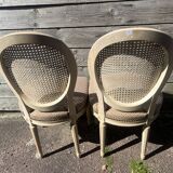 Pair of cerused chairs with fabric seats and caned backs.