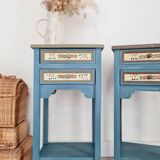 Blue wooden bedside tables with floral patterns