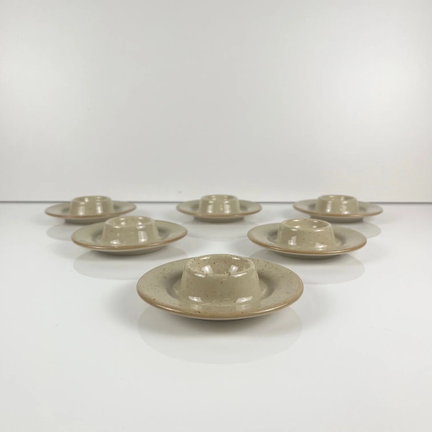 Set of 6 speckled beige ceramic egg cups.