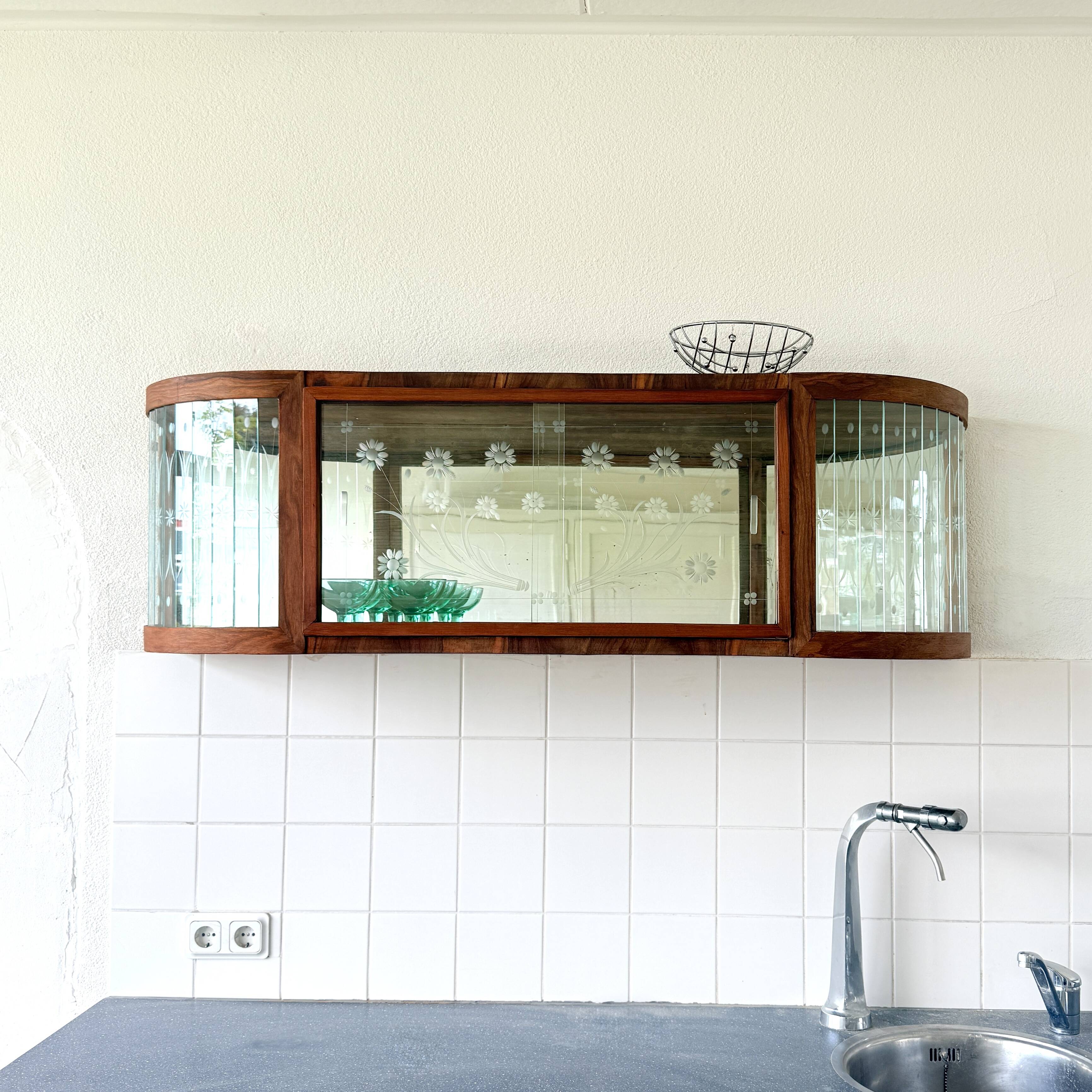 Art Deco-style wall-mounted display cabinet with floral engraving