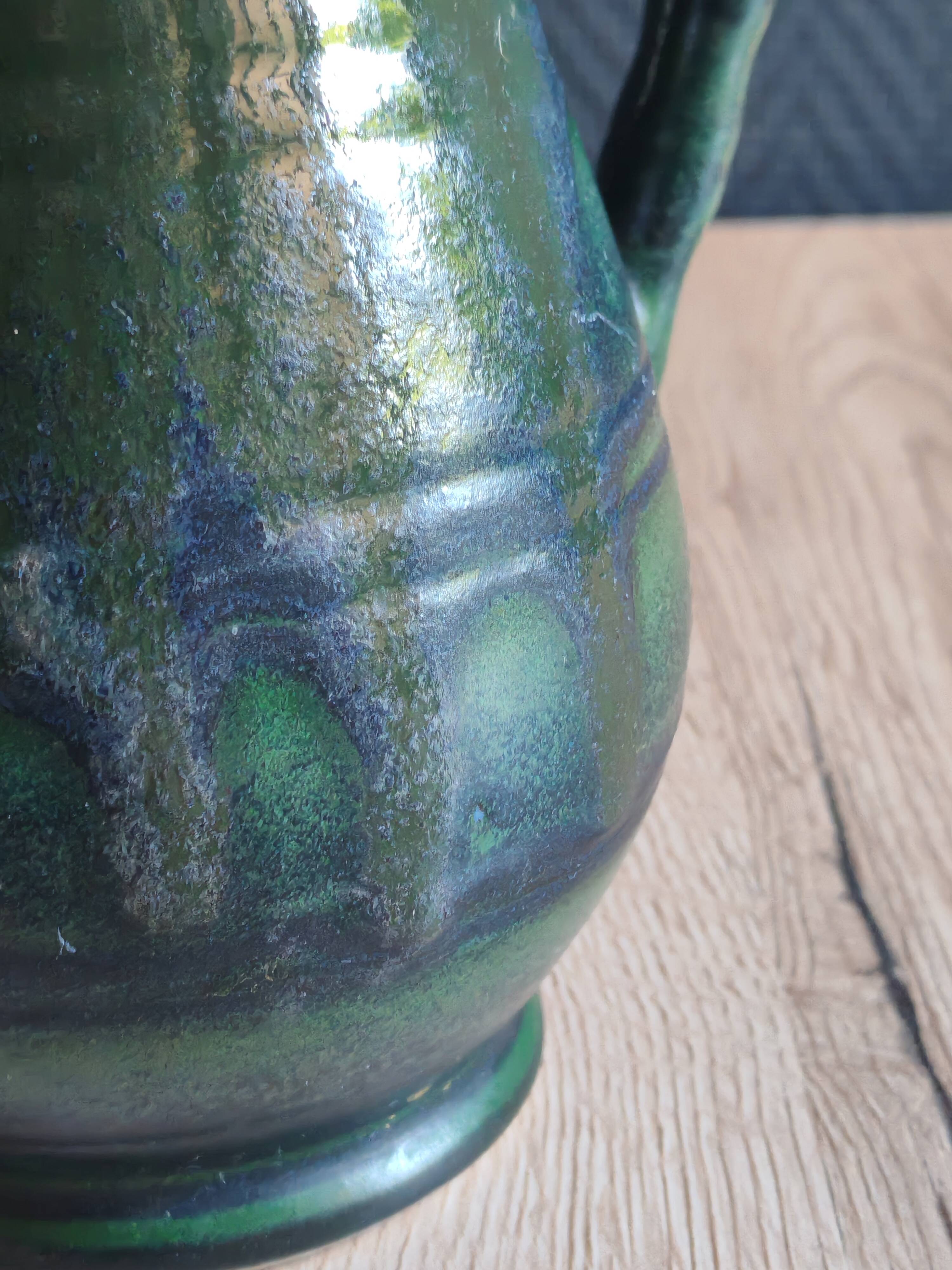 Vintage ceramic pitcher vase in glazed green and blue.