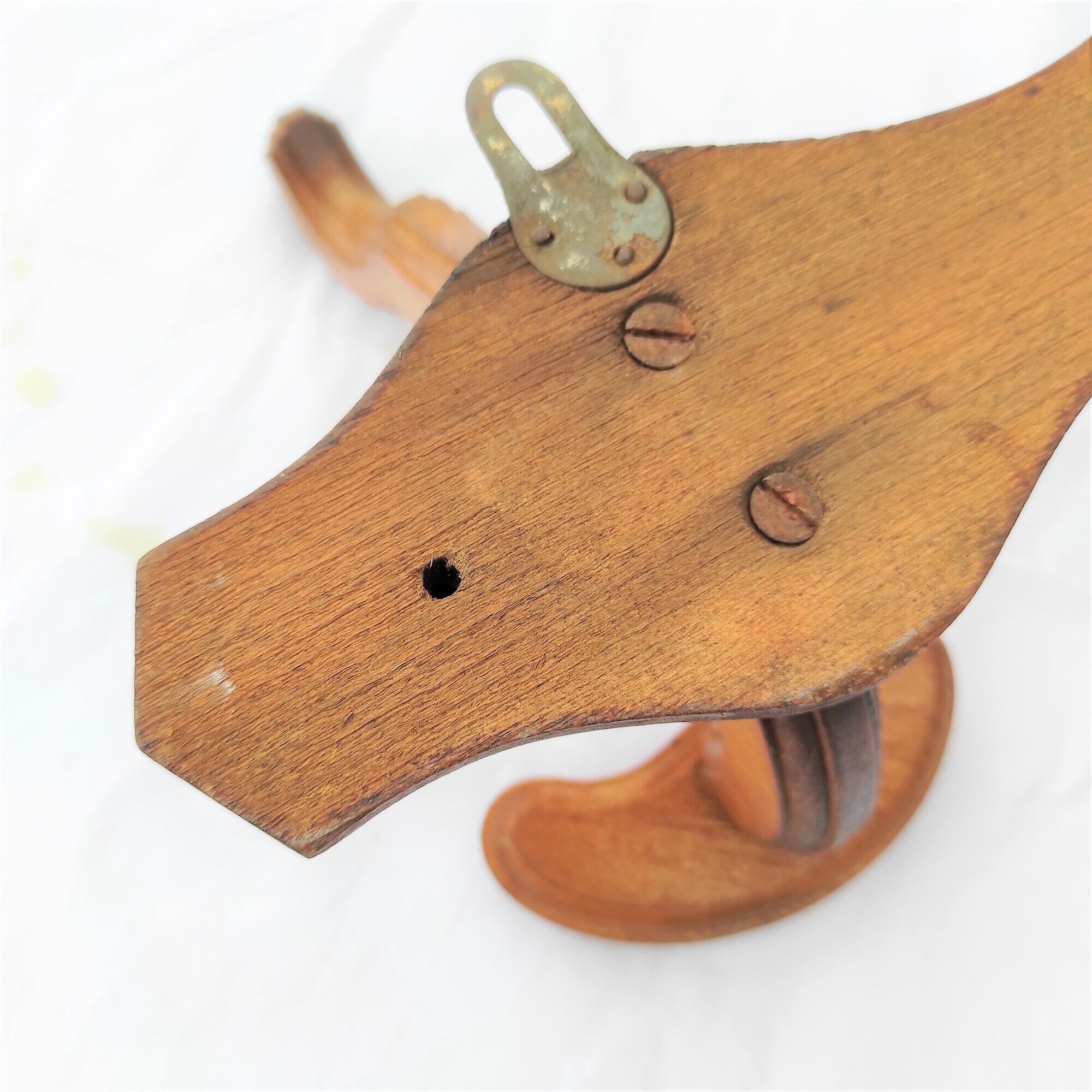 Wooden coats door with hat hanging in the center circa 1930