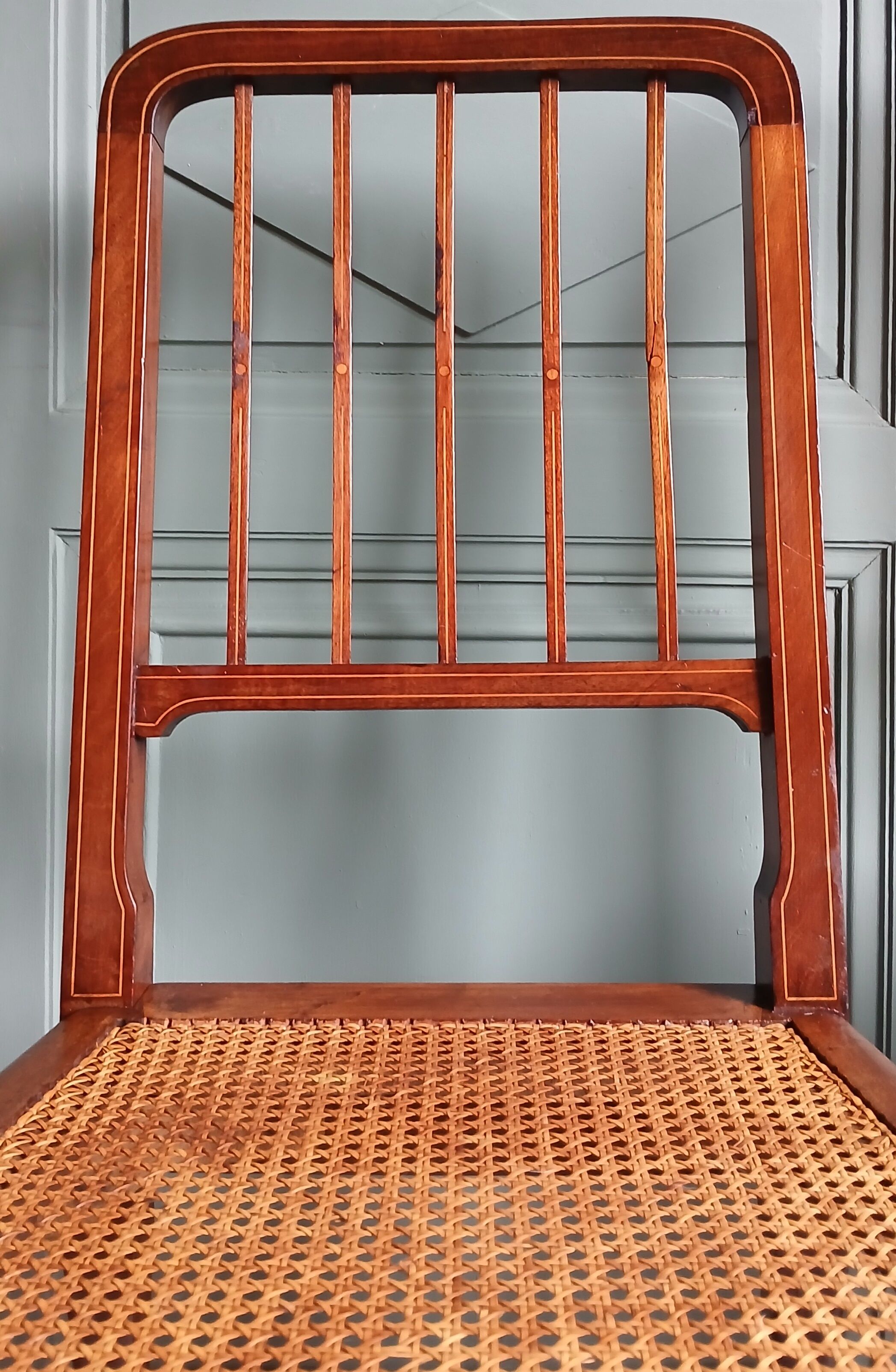 Pair of caned mahogany chairs, circa 1930.