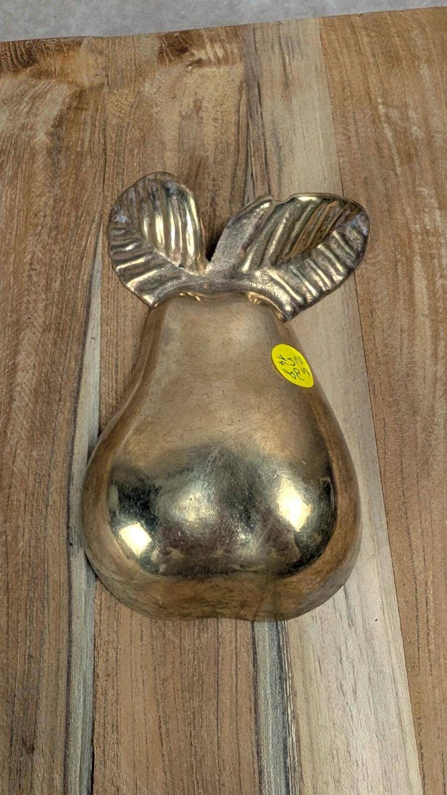 Small vintage brass trinket dish in the shape of a pear.