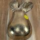 Small vintage brass trinket dish in the shape of a pear.