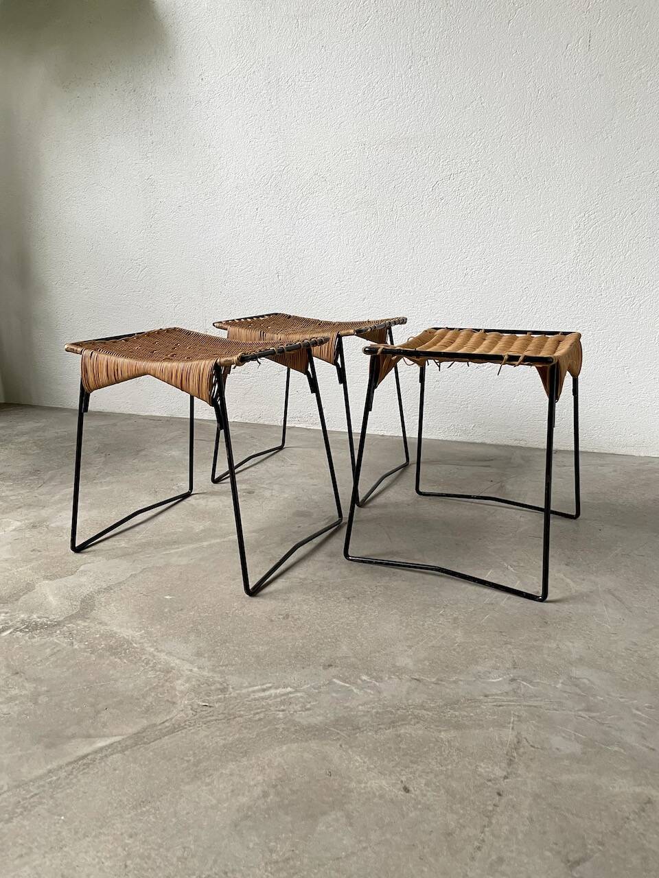 Set of three Raoul Guys wicker and metal stools