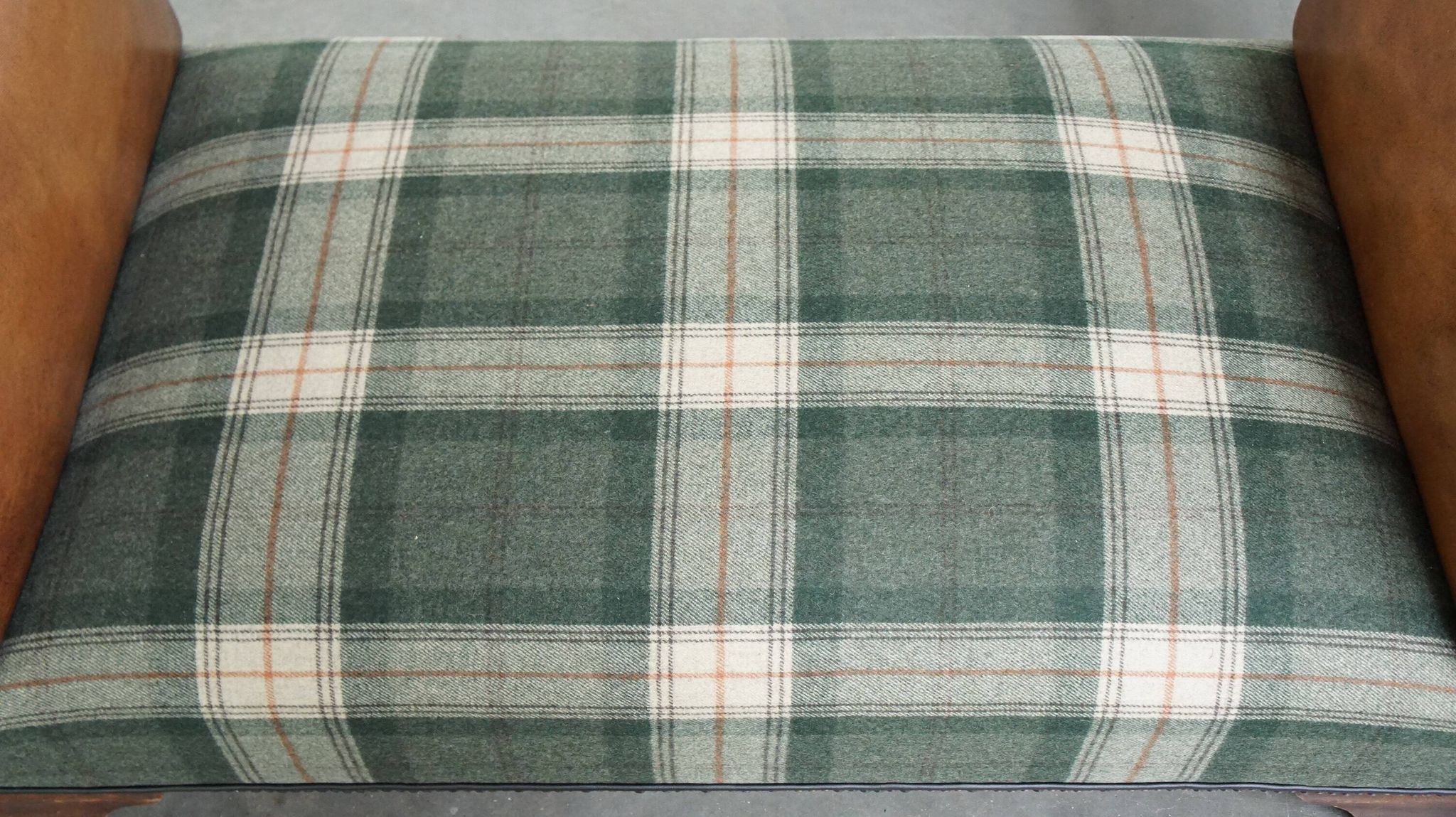 Antique daybed reupholstered with sheepskin and Scottish tartan wool