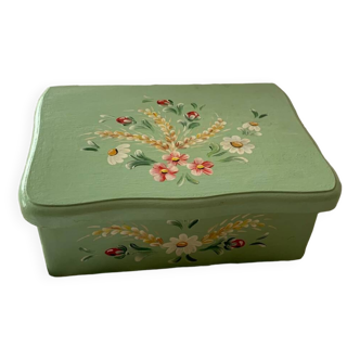 Wooden box painted light green with flowery flowers