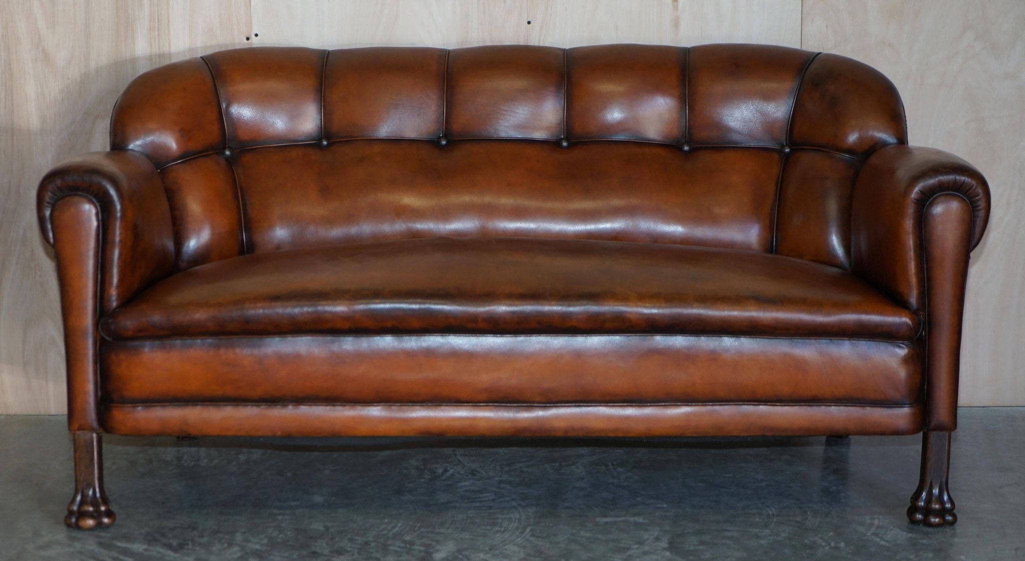 Victorian Chesterfield leather canapé with oak lion claw feet.