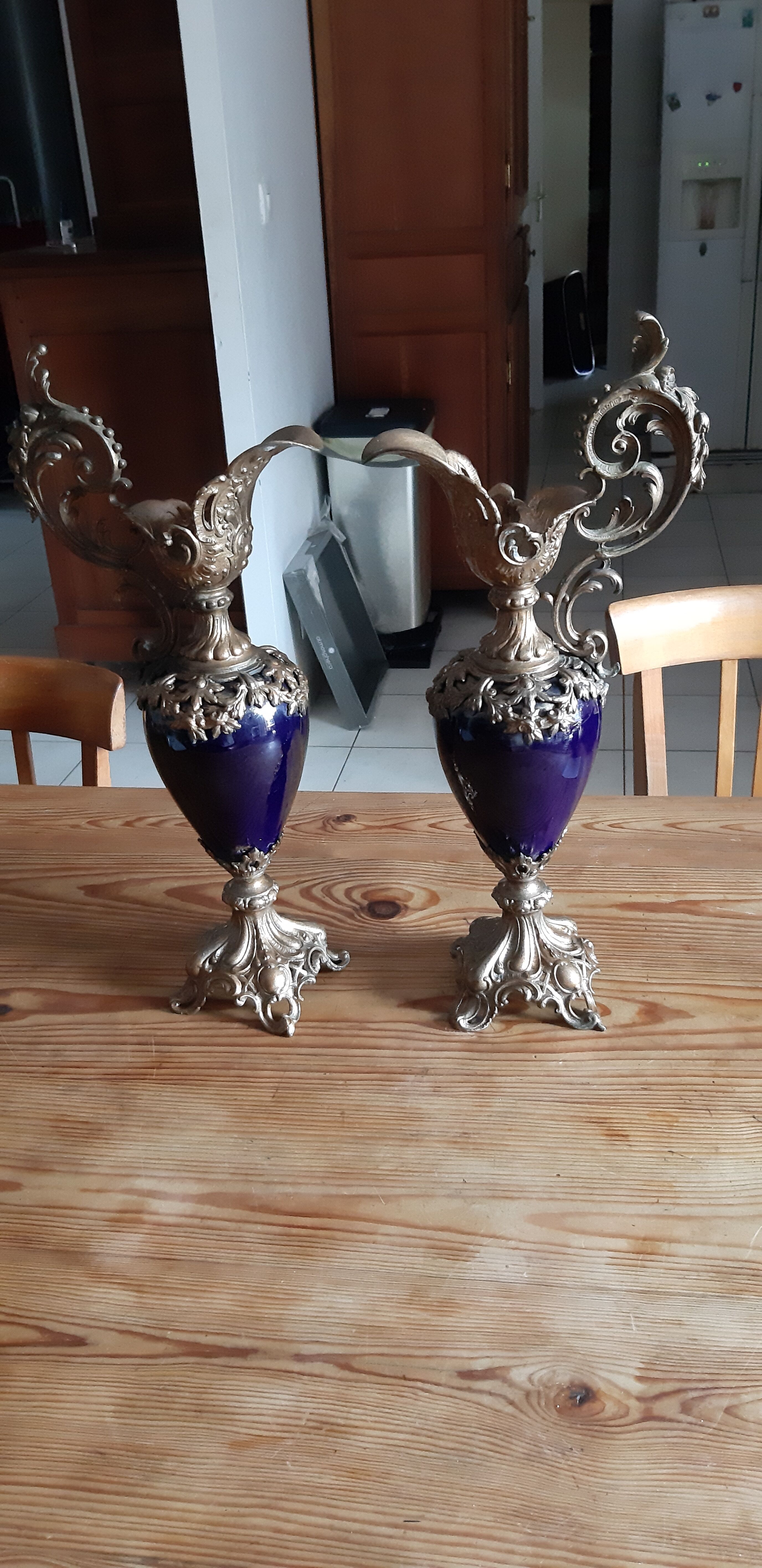 Pair of golden regulated ewers and blue glass