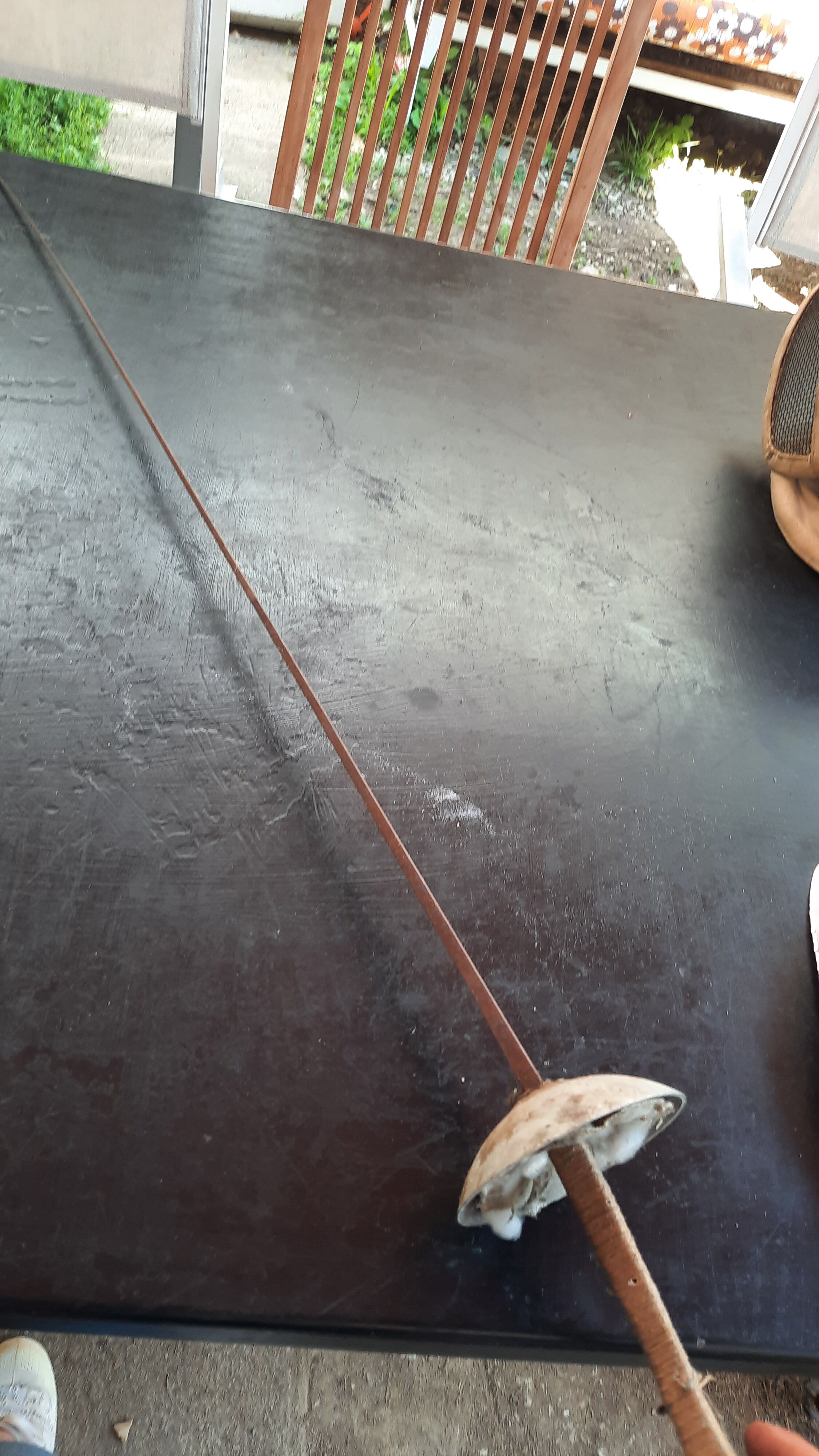 Pair of old fencing mask and foil