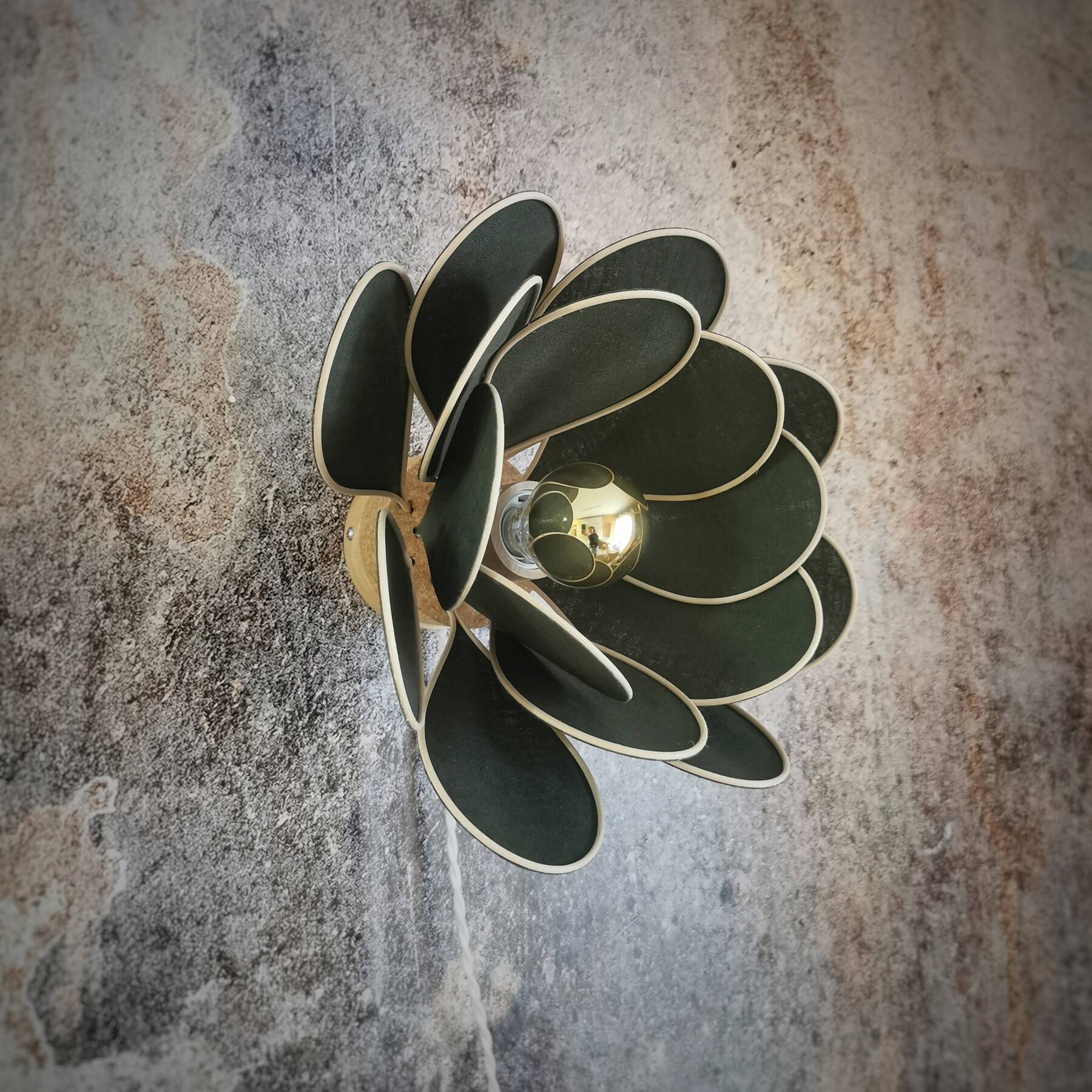 Wall lamp flower made of rattan and fir green linen.