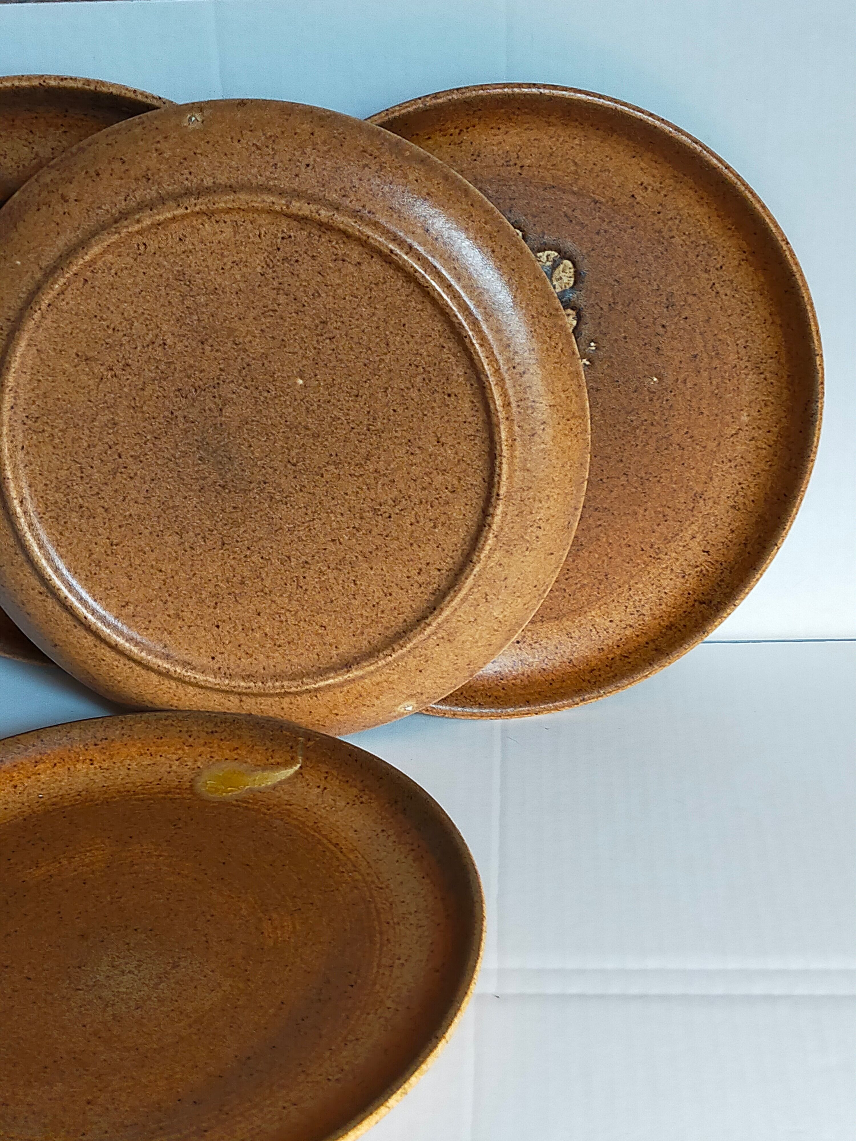 Four vintage glazed stoneware potter's plates