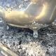 Footed pewter champagne cooler on claw feet with floral relief