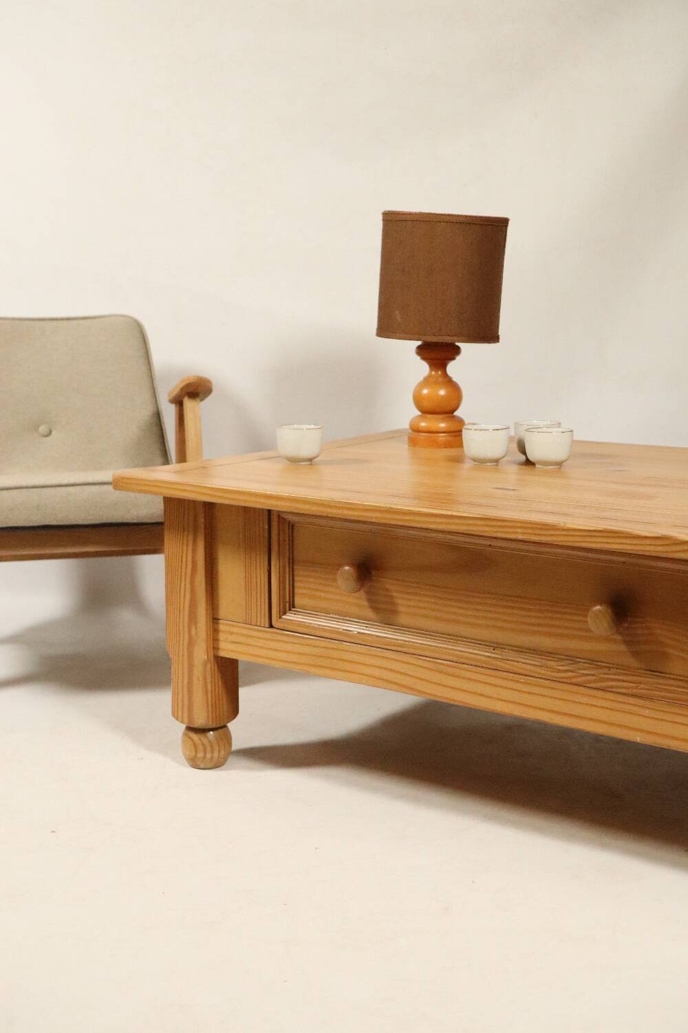 Rustic vintage style coffee table in light wood, mid-century modern design.