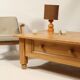 Rustic vintage style coffee table in light wood, mid-century modern design.
