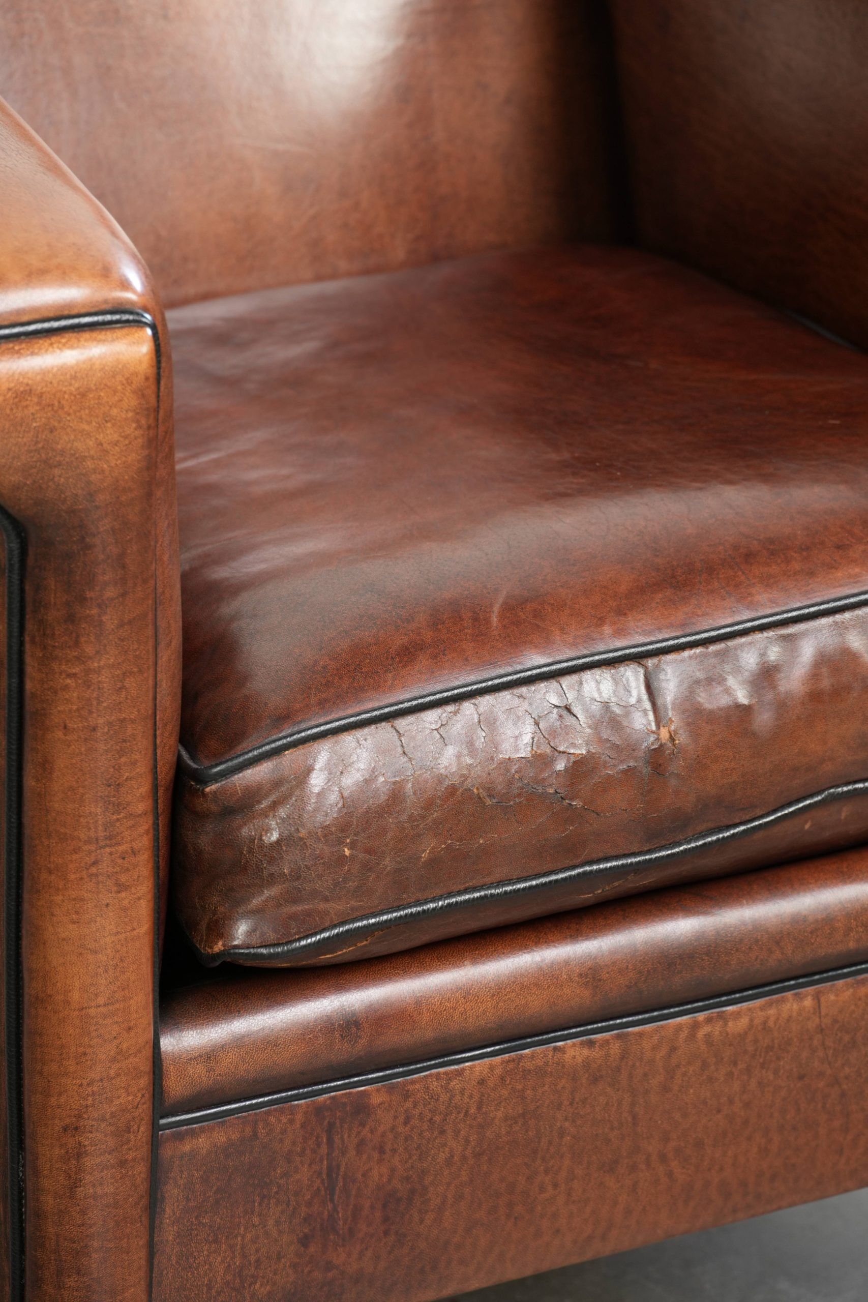 Sleek sheepskin Art Deco design armchair with black piping