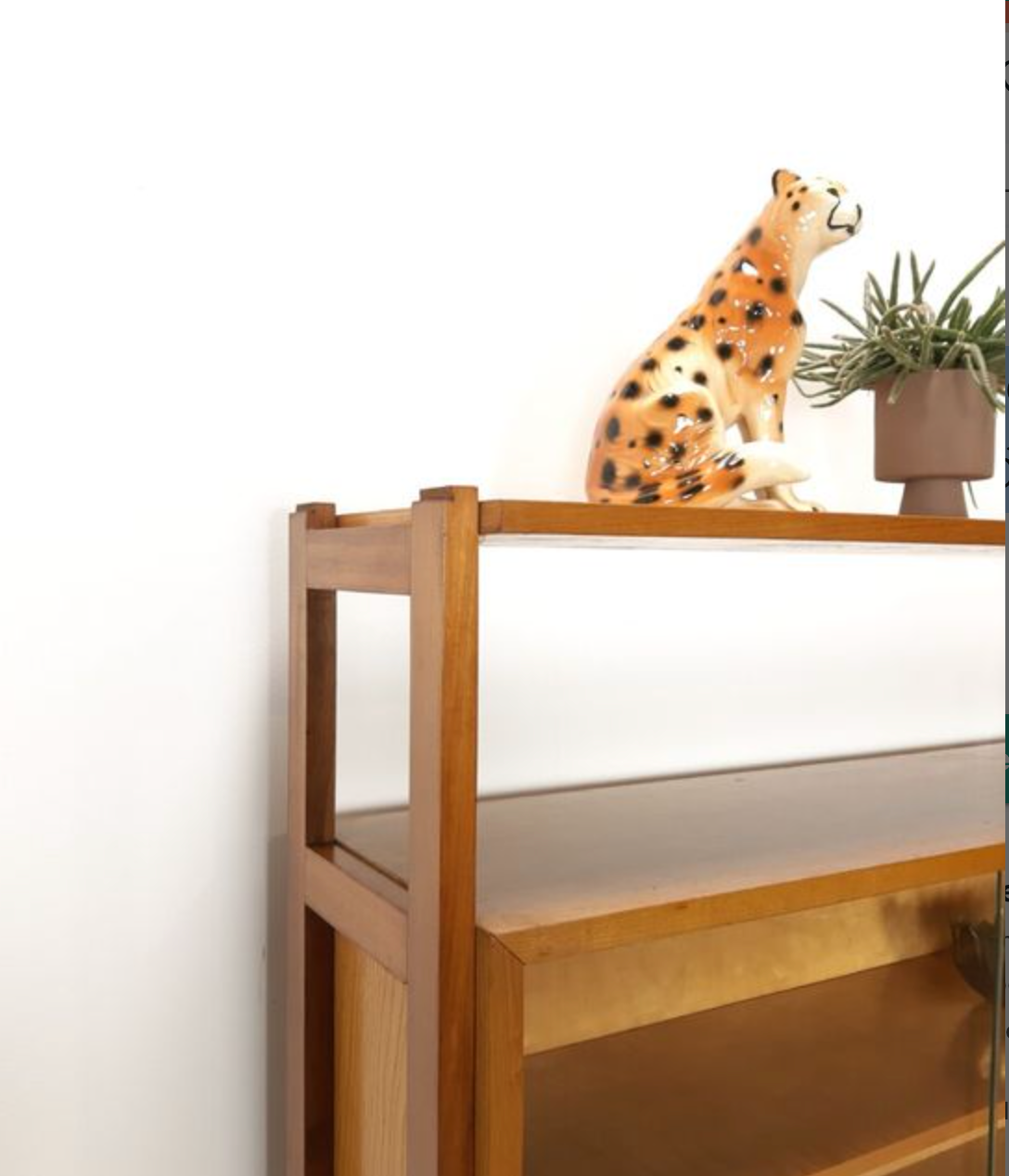 Vintage wooden showcase with sliding doors and white handles