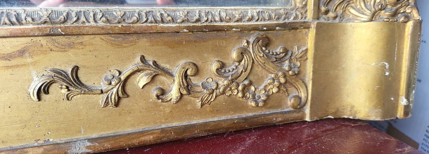Antique Louis Philippe style gilded mirror decorated with floral motifs