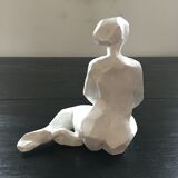 Statuette woman seated in plaster