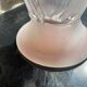 Pink glass vase decorated with tulips