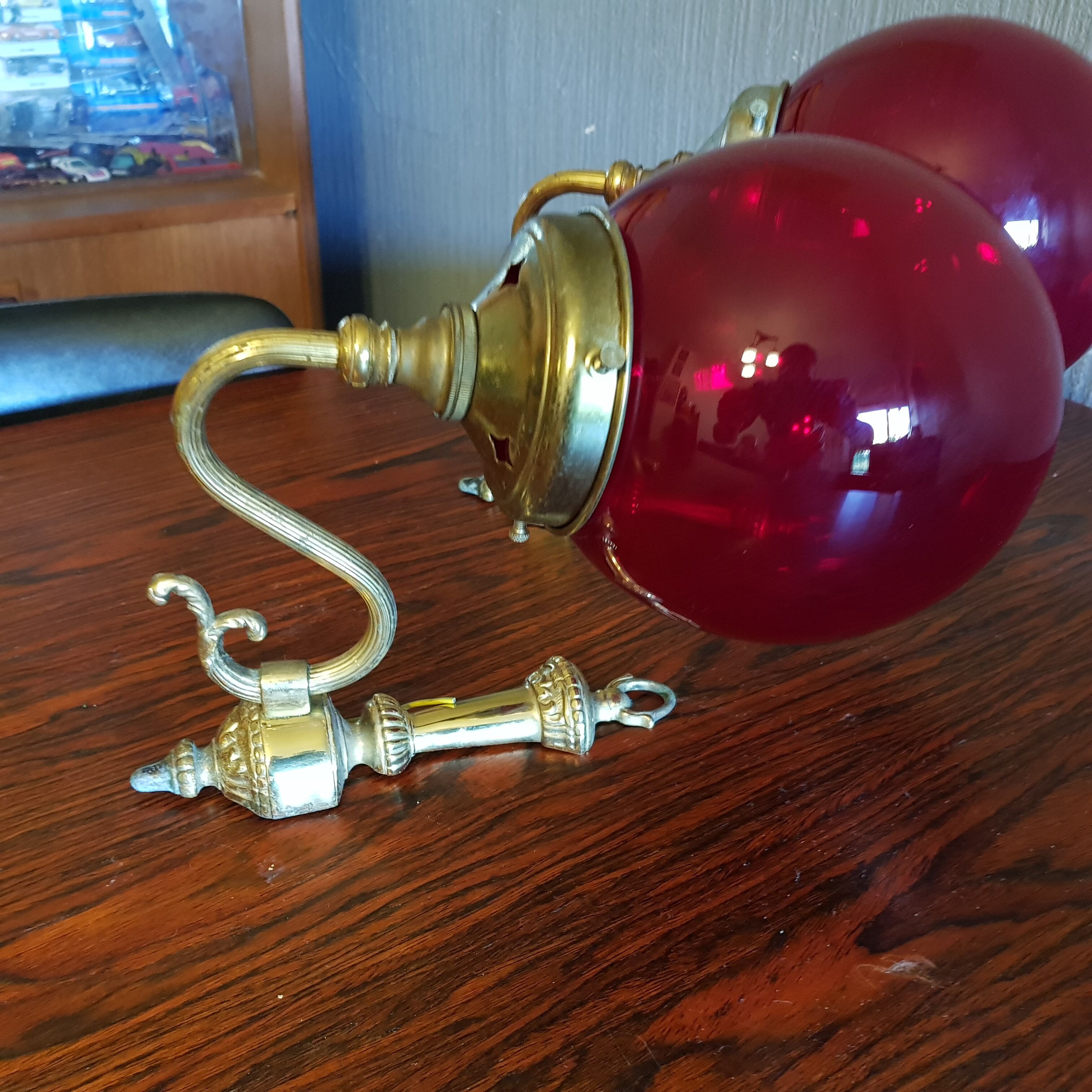 Pair of vintage brass wall light and cherry red globe